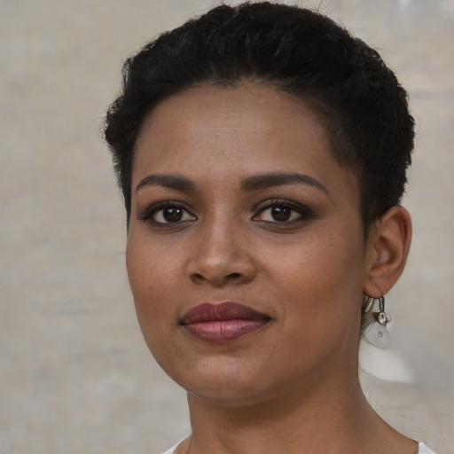 Joyful latino young-adult female with short  brown hair and brown eyes