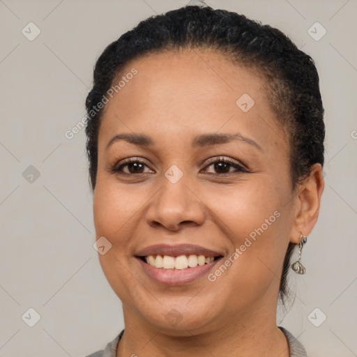 Joyful black young-adult female with short  brown hair and brown eyes