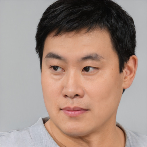 Neutral asian young-adult male with short  black hair and brown eyes