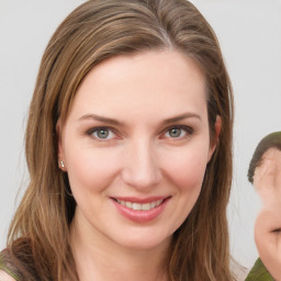 Joyful white young-adult female with medium  brown hair and green eyes