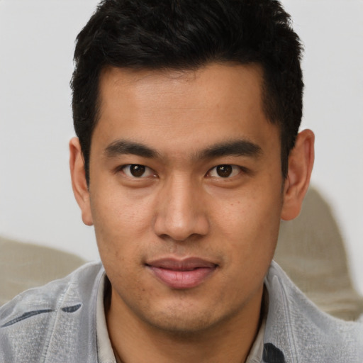 Joyful latino young-adult male with short  brown hair and brown eyes