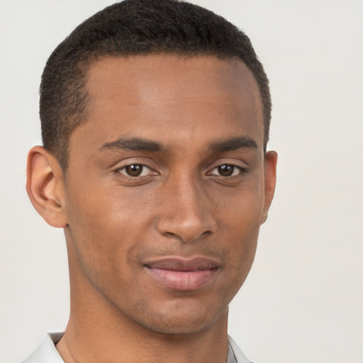 Joyful black young-adult male with short  brown hair and brown eyes