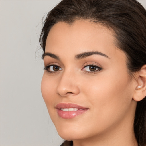 Joyful white young-adult female with long  brown hair and brown eyes