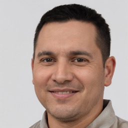 Joyful white adult male with short  brown hair and brown eyes