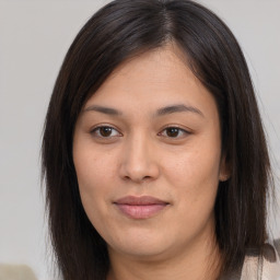 Joyful asian young-adult female with long  brown hair and brown eyes