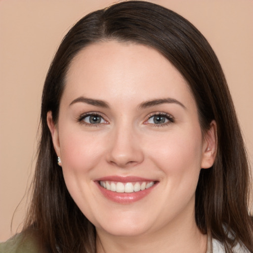 Joyful white young-adult female with long  brown hair and brown eyes