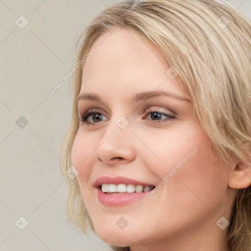 Joyful white young-adult female with long  brown hair and blue eyes