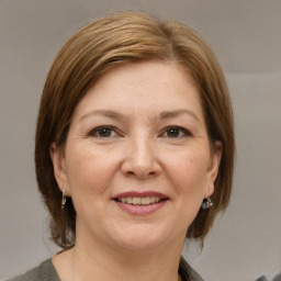 Joyful white adult female with medium  brown hair and grey eyes