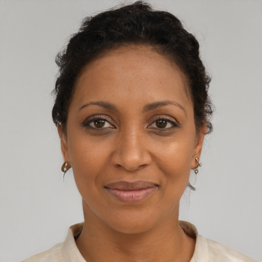Joyful black adult female with short  brown hair and brown eyes