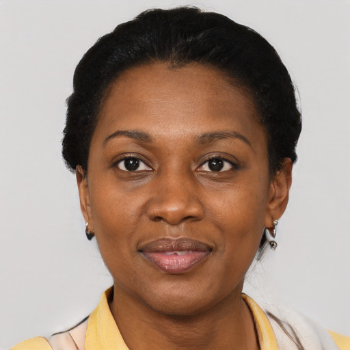 Joyful black adult female with short  black hair and brown eyes