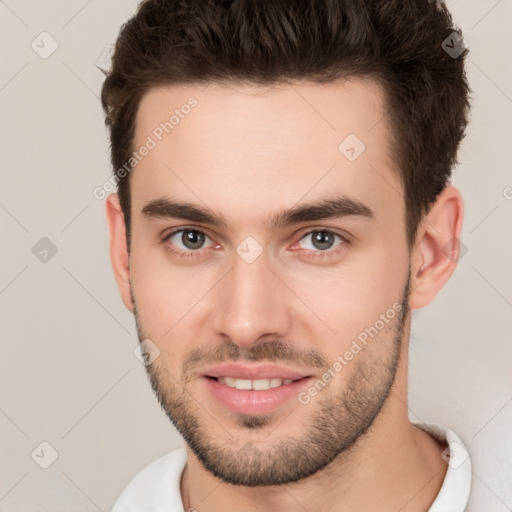 Joyful white young-adult male with short  brown hair and brown eyes