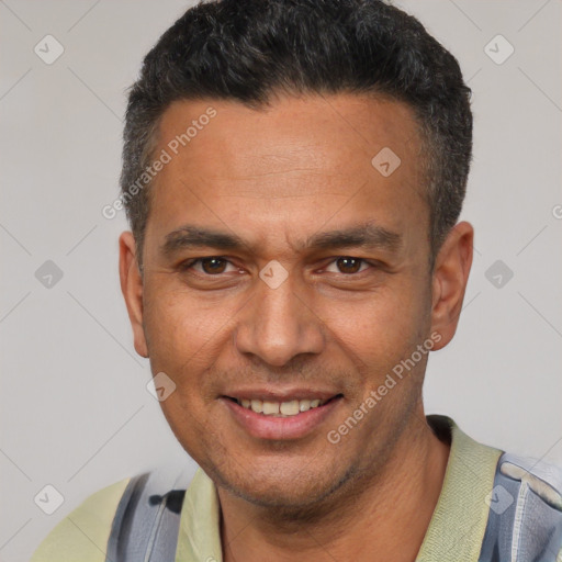 Joyful latino adult male with short  black hair and brown eyes