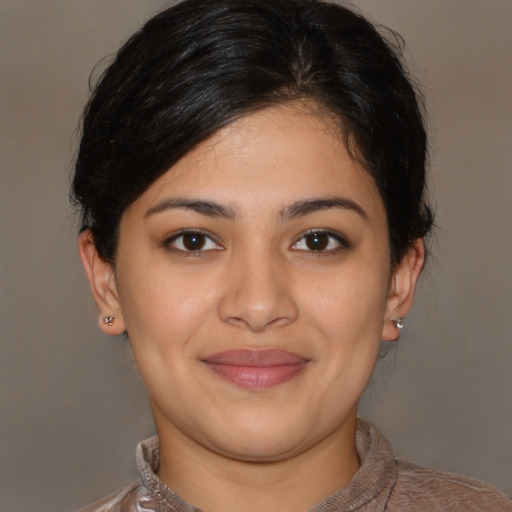 Joyful latino young-adult female with short  brown hair and brown eyes