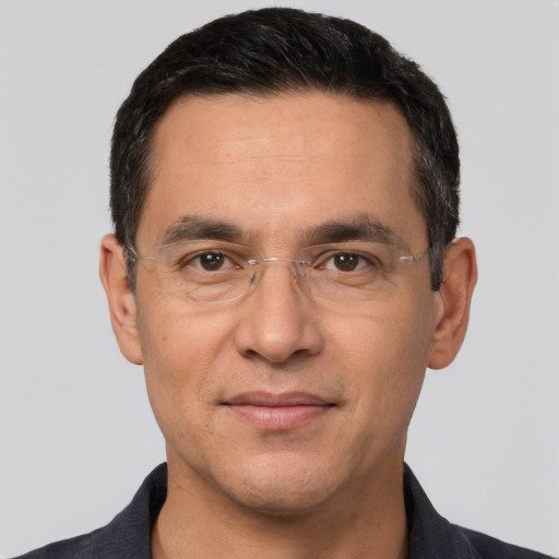 Joyful white adult male with short  black hair and brown eyes