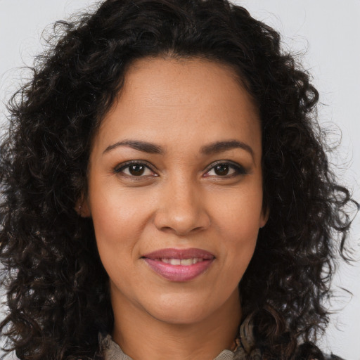 Joyful latino young-adult female with long  brown hair and brown eyes