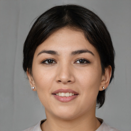 Joyful asian young-adult female with medium  black hair and brown eyes