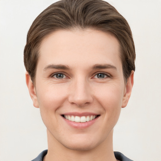 Joyful white young-adult female with short  brown hair and grey eyes