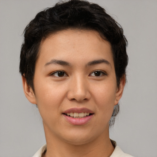 Joyful asian young-adult female with short  brown hair and brown eyes