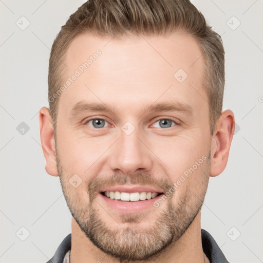 Joyful white young-adult male with short  brown hair and grey eyes