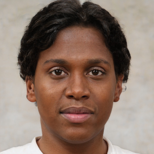 Joyful black young-adult female with short  brown hair and brown eyes
