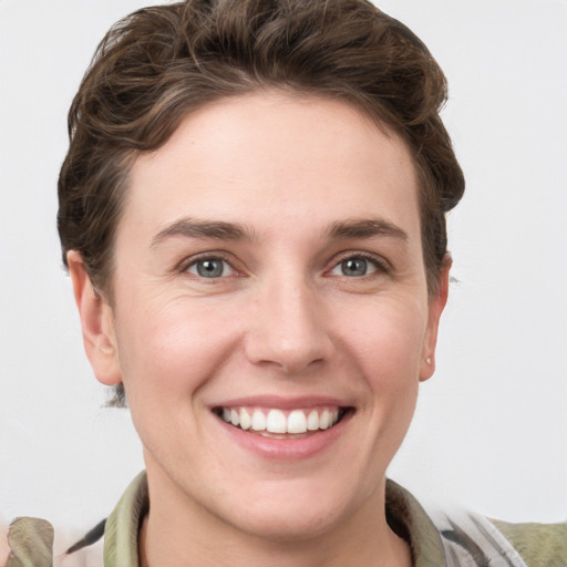 Joyful white young-adult female with short  brown hair and grey eyes