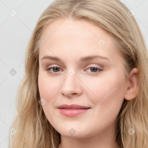 Joyful white young-adult female with long  brown hair and blue eyes