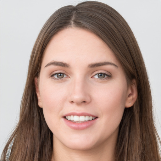 Joyful white young-adult female with long  brown hair and grey eyes