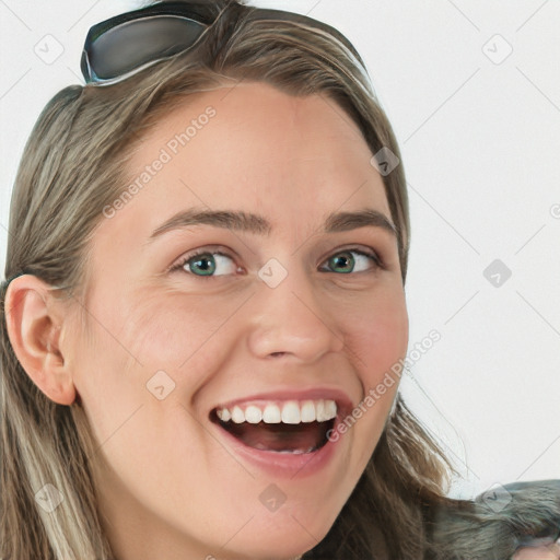 Joyful white young-adult female with long  brown hair and blue eyes