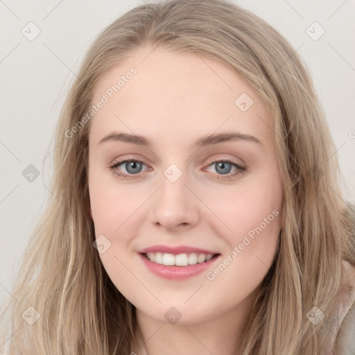 Joyful white young-adult female with long  brown hair and blue eyes