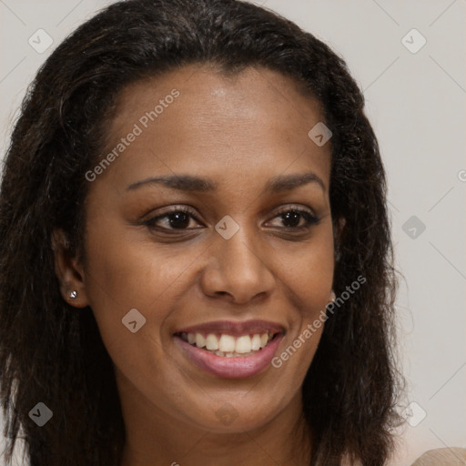 Joyful black young-adult female with long  brown hair and brown eyes