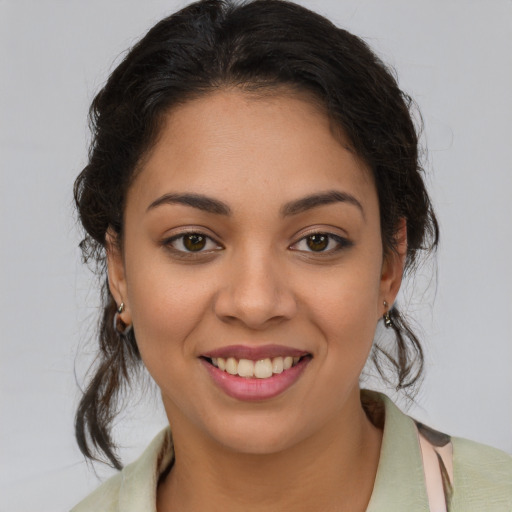 Joyful latino young-adult female with medium  brown hair and brown eyes