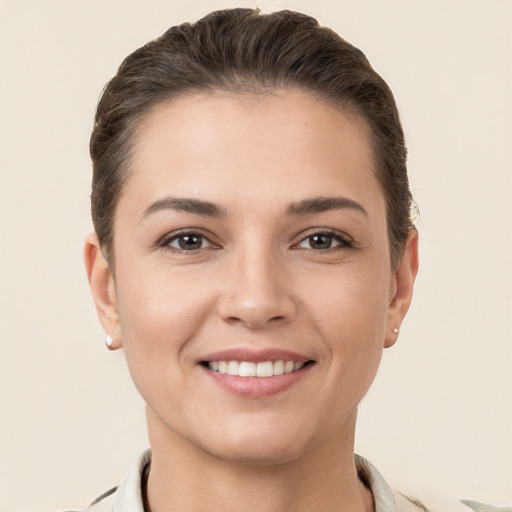 Joyful white young-adult female with short  brown hair and brown eyes