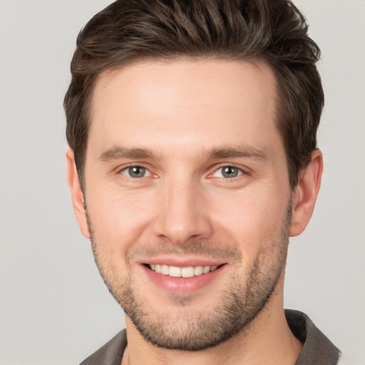 Joyful white young-adult male with short  brown hair and brown eyes