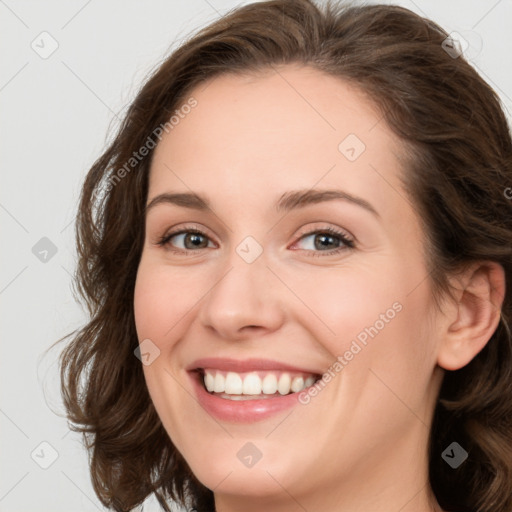 Joyful white young-adult female with long  brown hair and green eyes