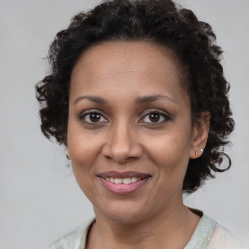 Joyful black adult female with short  brown hair and brown eyes