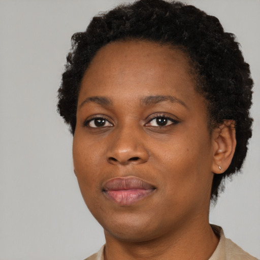 Joyful black young-adult female with short  black hair and brown eyes