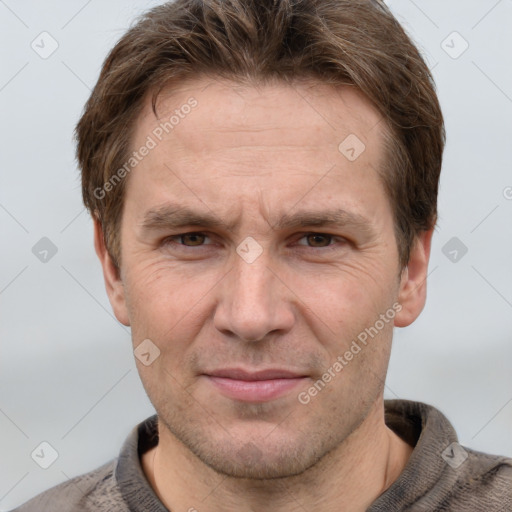 Joyful white adult male with short  brown hair and grey eyes