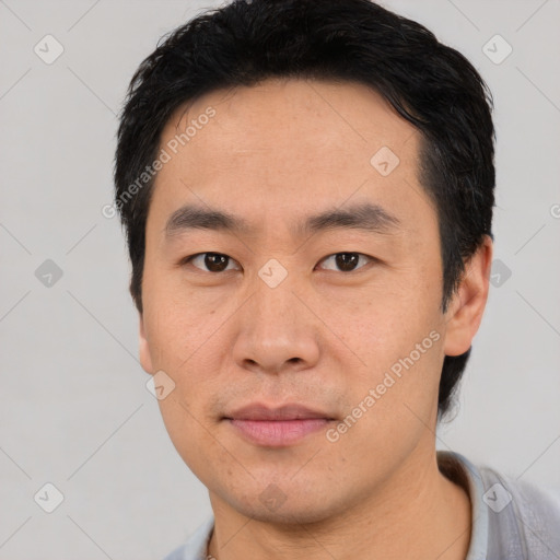 Joyful asian young-adult male with short  black hair and brown eyes