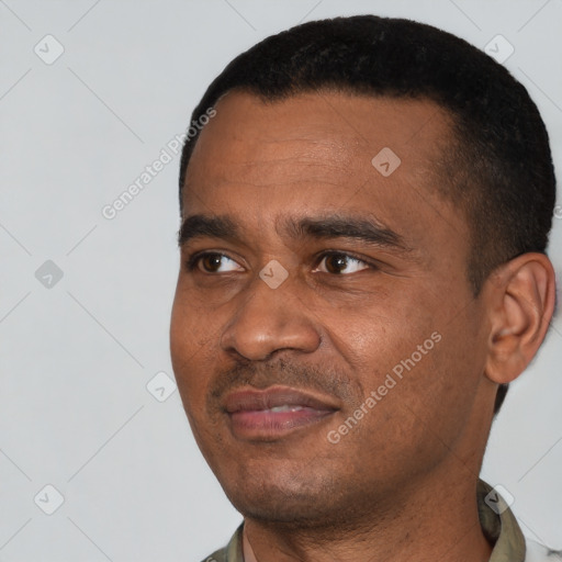 Joyful black young-adult male with short  black hair and brown eyes