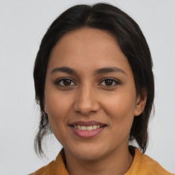 Joyful latino young-adult female with medium  brown hair and brown eyes