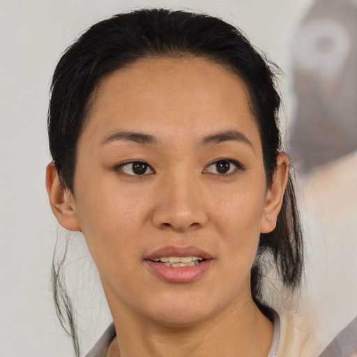 Joyful asian young-adult female with medium  black hair and brown eyes