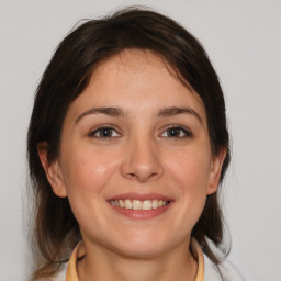 Joyful white young-adult female with medium  brown hair and brown eyes