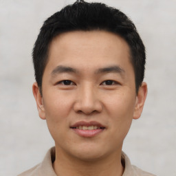 Joyful asian young-adult male with short  black hair and brown eyes