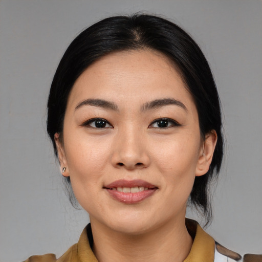 Joyful asian young-adult female with medium  black hair and brown eyes