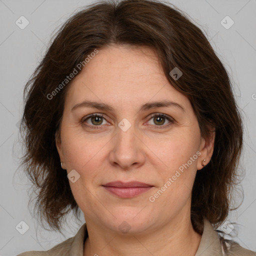 Joyful white adult female with medium  brown hair and grey eyes