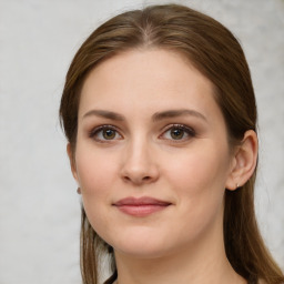 Joyful white young-adult female with long  brown hair and green eyes