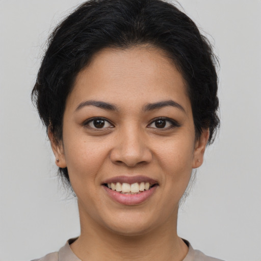 Joyful latino young-adult female with short  brown hair and brown eyes