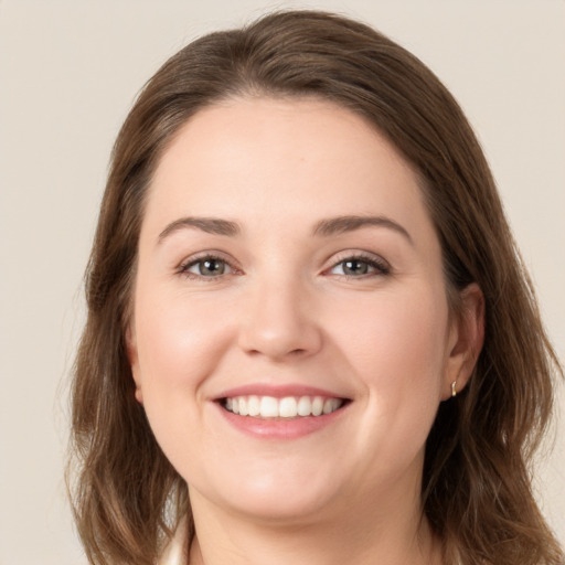 Joyful white young-adult female with long  brown hair and grey eyes