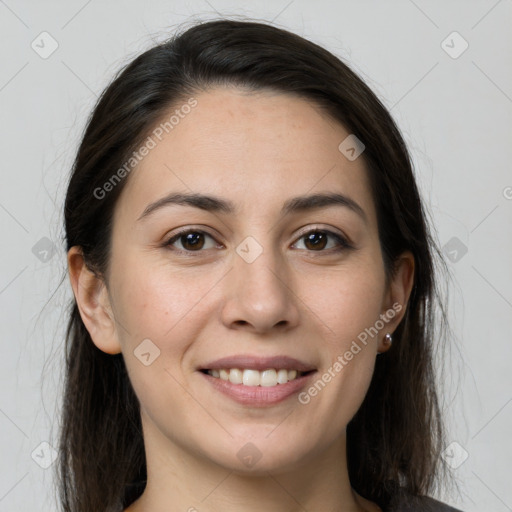 Joyful white young-adult female with long  brown hair and brown eyes