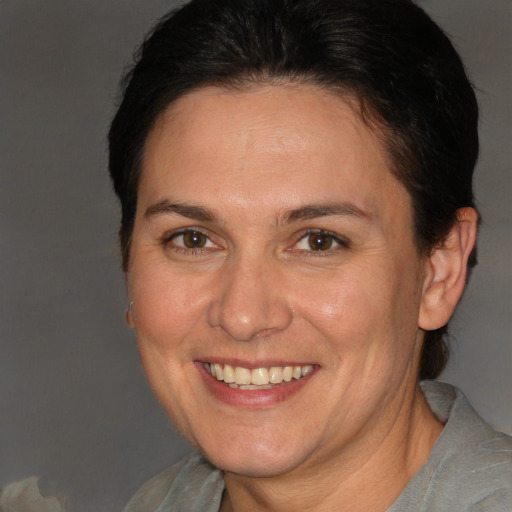 Joyful white adult female with short  brown hair and brown eyes